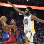 
              Miami Heat forward Jimmy Butler, left, shoots against Golden State Warriors forward Andrew Wiggins during the first half of an NBA basketball game in San Francisco, Thursday, Oct. 27, 2022. (AP Photo/Jeff Chiu)
            