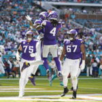 
              Minnesota Vikings tight end Irv Smith Jr. (84), top left, celebrates scoring a touchdown with teammates during the first half of an NFL football game against the Miami Dolphins, Sunday, Oct. 16, 2022, in Miami Gardens, Fla. (AP Photo/Lynne Sladky)
            