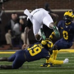 
              Michigan defensive back Rod Moore (19) upends Michigan State tight end Maliq Carr (6) in the first half of an NCAA college football game in Ann Arbor, Mich., Saturday, Oct. 29, 2022. (AP Photo/Paul Sancya)
            