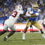 
              UCLA running back Zach Charbonnet (24) is tackled by Stanford defensive end David Bailey (23) during the first half of an NCAA college football game in Pasadena, Calif., Saturday, Oct. 29, 2022. (AP Photo/Ashley Landis)
            