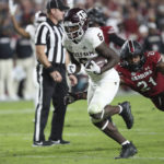 
              Texas A&M running back Devon Achane (6) runs away from South Carolina defensive back Nick Emmanwori (21) for a 15-yard touchdown during the second half of an NCAA college football game Saturday, Oct. 22, 2022, in Columbia, S.C. (AP Photo/Artie Walker Jr.)
            