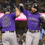 
              Colorado Rockies' Brendan Rodgers, right, is congratulated by C.J. Cron after hitting a solo home run during the first inning of a baseball game against the Los Angeles Dodgers Tuesday, Oct. 4, 2022, in Los Angeles. (AP Photo/Mark J. Terrill)
            
