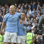 
              Manchester City's Phil Foden, right, celebrates with his teammate Erling Haaland after scoring his side's sixth goal and his personal hat trick during the English Premier League soccer match between Manchester City and Manchester United at Etihad stadium in Manchester, England, Sunday, Oct. 2, 2022. (AP Photo/Rui Vieira)
            