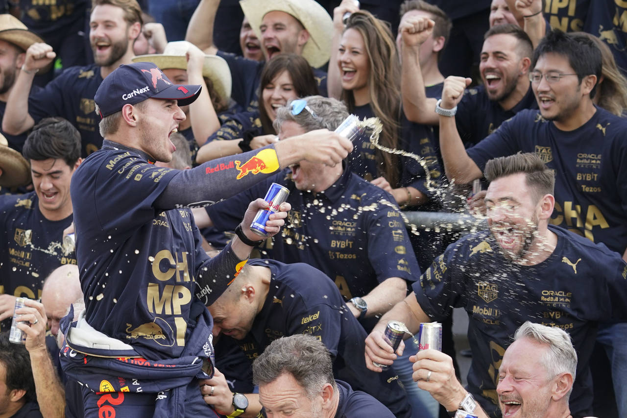 Red Bull driver Max Verstappen, of the Netherlands, celebrates with the Red Bull team following the...