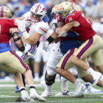 
              SMU running back Tyler Lavine (31) spins off an attempted tackle by Tulsa defensive lineman Joseph Anderson and safety Bryson Powers (21) during the second quarter of an NCCA college football game in Tulsa, Okla., on Saturday, Oct. 29, 2022. (Ian Maule/Tulsa World via AP)
            