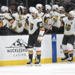 
              Vegas Golden Knights defenseman Shea Theodore (27) is congratulated for his goal during the second period of the team's NHL hockey game against the Seattle Kraken, Saturday, Oct. 15, 2022, in Seattle. (AP Photo/Jason Redmond)
            