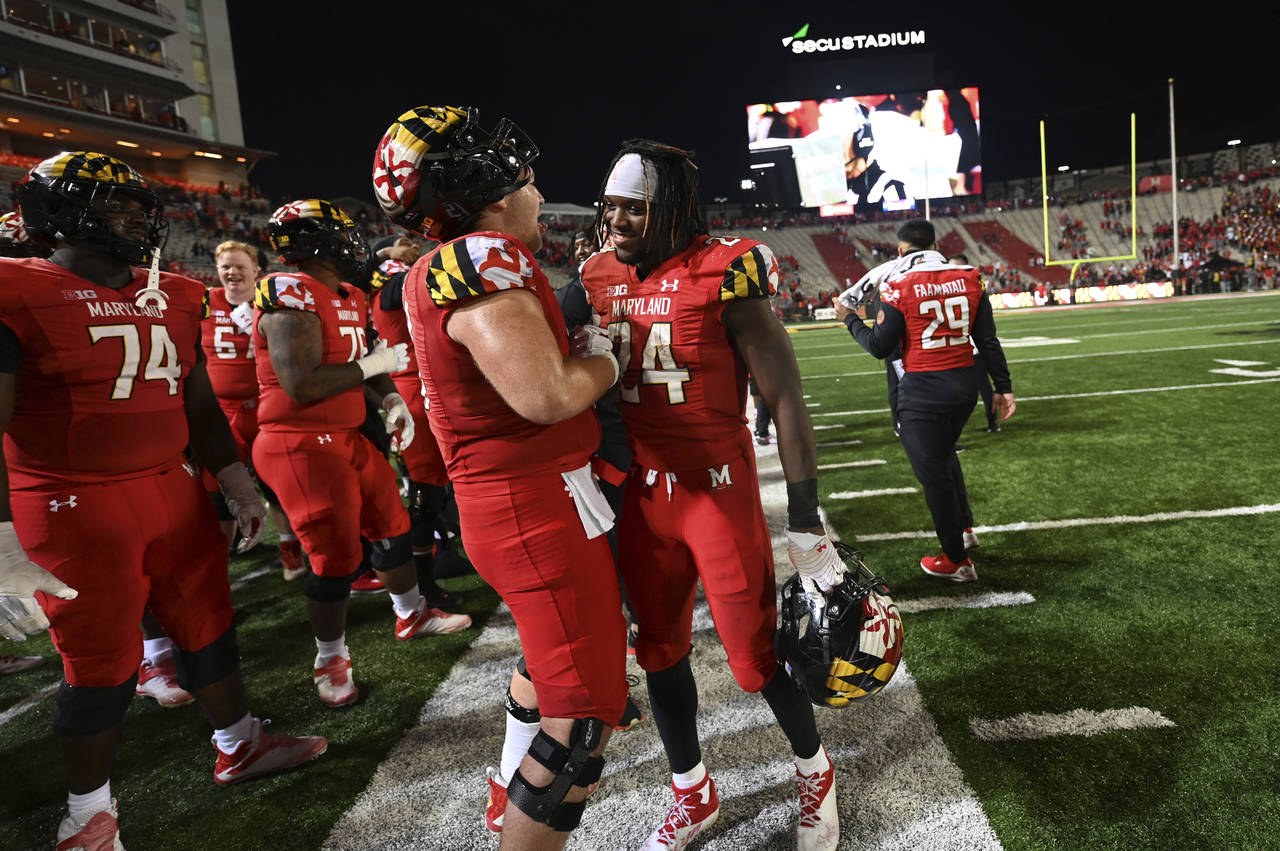 Maryland running back Roman Hemby (24) is congratulated on the sideline after defeating Northwester...