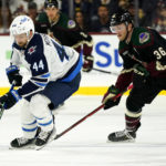 
              Winnipeg Jets defenseman Josh Morrissey (44) skates with the puck against Arizona Coyotes right wing Christian Fischer (36) during the first period of an NHL hockey game at Mullett Arena in Tempe, Ariz., Friday, Oct. 28, 2022. (AP Photo/Ross D. Franklin)
            