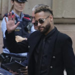 
              Former FC Barcelona player Neymar who now plays for Paris Saint-Germain waves on arrival at a court in Barcelona, Spain, Monday Oct. 17, 2022. Neymar returned to Spain Monday to face trial on fraud charges regarding his 2013 transfer from Santos to FC Barcelona. The Brazilian forward, his father, and the former executives of Barcelona and Santos are accused of hiding the true cost of his transfer with the alleged goal of cheating a private Brazilian company.(AP Photo/Joan Mateu Parra)
            