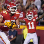 
              Kansas City Chiefs tight end Travis Kelce (87) celebrates after scoring on a 4-yard touchdown catch as teammate Marquez Valdes-Scantling (11) cheers in the background during the second half of an NFL football game against the Las Vegas Raiders Monday, Oct. 10, 2022, in Kansas City, Mo. (AP Photo/Ed Zurga)
            