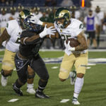 
              Colorado State running back Avery Morrow (25) stiff-arms Nevada linebacker Eli'jah Winston (4) iduringthe first half of an NCAA college football game in Reno, Nev., Friday, Oct. 7, 2022. (AP Photo/Tom R. Smedes)
            