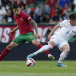 
              FILE - Portugal's Joao Cancelo, left, challenges for the ball with Czech Republic's Adam Hlozek during the UEFA Nations League soccer match between Portugal and the Czech Republic, at the Jose Alvalade Stadium in Lisbon, Thursday, June 9, 2022. (AP Photo/Armando Franca, File)
            