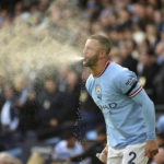
              Manchester City's Kyle Walker spits water during the English Premier League soccer match between Manchester City and Manchester United at Etihad stadium in Manchester, England, Sunday, Oct. 2, 2022. (AP Photo/Rui Vieira)
            