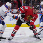 
              Chicago Blackhawks center Jonathan Toews, front right, controls the puck against Edmonton Oilers center Leon Draisaitl, left, during the first period of an NHL hockey game in Chicago, Thursday, Oct. 27, 2022. (AP Photo/Nam Y. Huh)
            