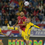 
              FILE - Serbia's Aleksandar Mitrovic, center, scores his side's first goal past Sweden's goalkeeper Robin Olsen during the UEFA Nations League soccer match between Serbia and Sweden at the Rajko Mitic Stadium in Belgrade, Serbia, Saturday, Sept. 24, 2022. (AP Photo/Darko Vojinovic, File)
            