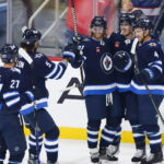 
              Winnipeg Jets' Nikolaj Ehlers (27), Brenden Dillon (5), Kyle Connor (81), Mark Scheifele (55) and Neal Pionk (4) celebrate Scheifele's goal against the New York Rangers during the first period of an NHL hockey game Friday, Oct. 14, 2022, in Winnipeg, Manitoba. (John Woods/The Canadian Press via AP)
            