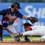 
              Philadelphia Phillies Jean Segura (2) steals second base as Atlanta Braves shortstop Dansby Swanson (7) misses the tag during the sixth inning in Game 4 of baseball's National League Division Series, Saturday, Oct. 15, 2022, in Philadelphia. (AP Photo/Matt Rourke)
            
