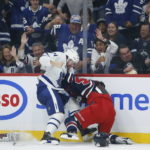
              Winnipeg Jets' Josh Morrissey, right, and Toronto Maple Leafs' Morgan Rielly fight during the second period of an NHL hockey game Saturday, Oct. 22, 2022, in Winnipeg, Manitoba. (John Woods/The Canadian Press via AP)
            