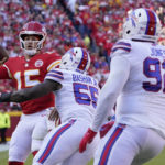 
              Kansas City Chiefs quarterback Patrick Mahomes (15) throws under pressure from Buffalo Bills defensive end Boogie Basham (55) and defensive tackle DaQuan Jones (92) during the first half of an NFL football game Sunday, Oct. 16, 2022, in Kansas City, Mo. (AP Photo/Ed Zurga)
            