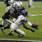 
              Houston Texans wide receiver Phillip Dorsett bobbles the ball before scoring a touchdown as Las Vegas Raiders safety Tre'von Moehrig (25) and cornerback Anthony Averett defend during the second half of an NFL football game Sunday, Oct. 23, 2022, in Las Vegas. (AP Photo/John Locher)
            