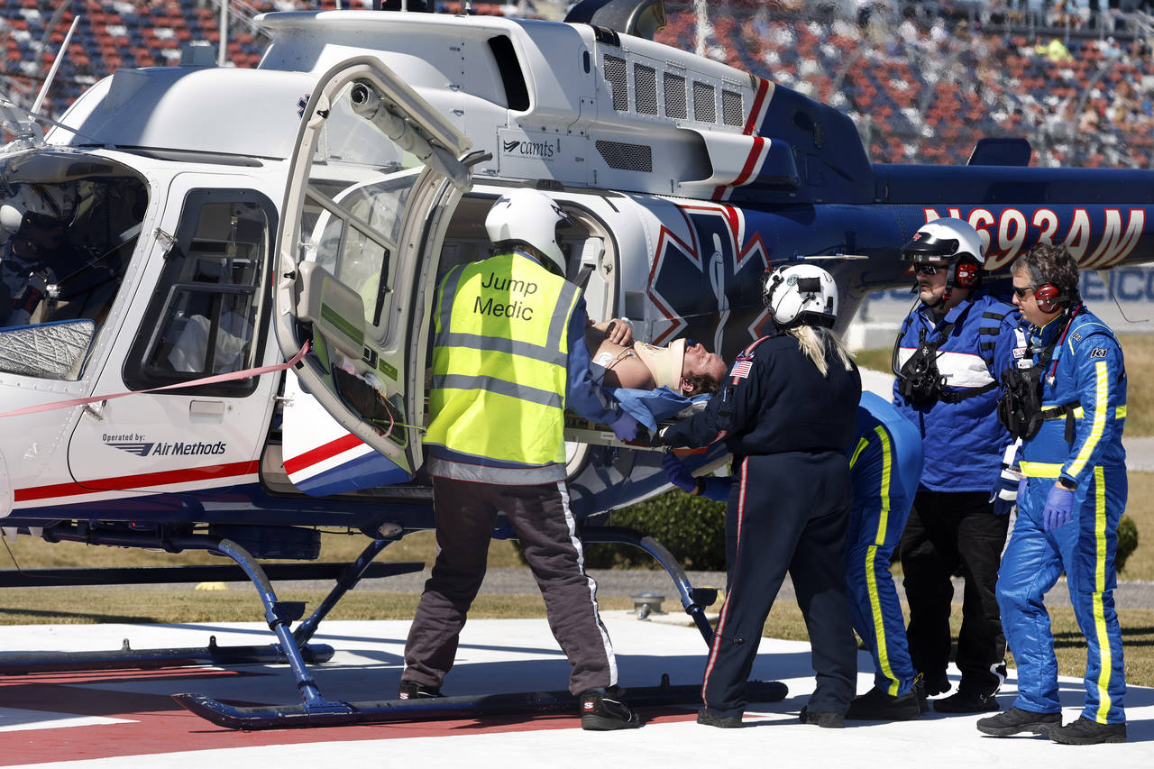 Driver Jordan Anderson is loaded into a helicopter after a fiery crash during the NASCAR Trucks Che...
