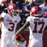 
              Oklahoma wide receiver Jalil Farooq (3) celebrates with teammate wide receiver Marvin Mims (17) after catching a 41-yard touchdown pass during the second half of an NCAA college football game against Iowa State, Saturday, Oct. 29, 2022, in Ames, Iowa. Oklahoma won 27-13. (AP Photo/Charlie Neibergall)
            