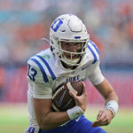
              Duke quarterback Riley Leonard runs the ball in for a touchdown during the first half of an NCAA college football game against Miami, Saturday, Oct. 22, 2022, in Miami Gardens, Fla. (AP Photo/Wilfredo Lee)
            