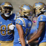 
              UCLA receiver Logan Loya (17) celebrates with tight end Michael Ezeike (86) and wide receiver Titus Mokiao-Atimalala (2) after scoring a touchdown during the second half of an NCAA college football game against Utah in Pasadena, Calif., Saturday, Oct. 8, 2022. (AP Photo/Ashley Landis)
            