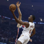 
              Cleveland Cavaliers center Evan Mobley (4) goes up for a shot against Washington Wizards center Kristaps Porzingis during the first half of a NBA basketball game, Sunday, Oct. 23, 2022, in Cleveland. (AP Photo/Ron Schwane)
            