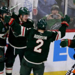 
              Minnesota Wild left wing Kirill Kaprizov (97) celebrates with Ryan Hartman (38), Calen Addison (2) and Mats Zuccarello (36) after scoring against the Vancouver Canucks in overtime of an NHL hockey game Thursday, Oct. 20, 2022, in St. Paul, Minn. (AP Photo/Andy Clayton-King)
            