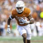 
              Texas running back Bijan Robinson carries against West Virginia during the first half of an NCAA college football game Saturday, Oct. 1, 2022, in Austin, Texas. (AP Photo/Stephen Spillman)
            
