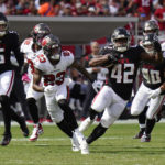 
              Atlanta Falcons running back Caleb Huntley (42) runs for a first down as Tampa Bay Buccaneers cornerback Sean Murphy-Bunting (23) gives chase during the second half of an NFL football game Sunday, Oct. 9, 2022, in Tampa, Fla. (AP Photo/Chris O'Meara)
            