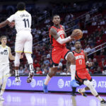 
              Houston Rockets guard Kevin Porter Jr. jumps to pass the ball as Utah Jazz guard Mike Conley (11) defends while forward Lauri Markkanen (23) and forward Tari Eason (17) look on during the first half of an NBA basketball game, Monday, Oct. 24, 2022, in Houston. (AP Photo/Michael Wyke)
            
