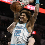 
              Charlotte Hornets' Kelly Oubre Jr. dunks during the first half of an NBA basketball game against the San Antonio Spurs, Wednesday, Oct. 19, 2022, in San Antonio. (AP Photo/Darren Abate)
            