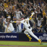 
              San Diego Padres' Jake Cronenworth reacts after hitting a two-run single during the seventh inning in Game 4 of a baseball NL Division Series against the Los Angeles Dodgers, Saturday, Oct. 15, 2022, in San Diego. (AP Photo/Jae C. Hong)
            