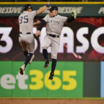 
              New York Yankees' Oswaldo Cabrera, left, and Harrison Bader celebrate after the Yankees defeated the Cleveland Guardians in Game 4 of a baseball AL Division Series, Sunday, Oct. 16, 2022, in Cleveland. (AP Photo/Phil Long)
            