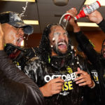 
              The San Diego Padres celebrate in the locker room after defeating the New York Mets in Game 3 of a National League wild-card baseball playoff series to advance to the National League Division Series against the Lost Angeles Dodgers, Sunday, Oct. 9, 2022, in New York. (AP Photo/Frank Franklin II)
            