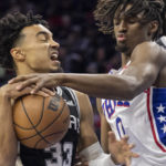 
              San Antonio Spurs guard Tre Jones (33) is fouled by Philadelphia 76ers guard Tyrese Maxey (0) during the first half on an NBA basketball game, Saturday, Oct. 22, 2022, in Philadelphia. (AP Photo/Laurence Kesterson)
            