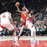 
              Atlanta Hawks guard Trent Forrest (2) shoots in the paint as Toronto Raptors forward Christian Koloko (35) defends during second-half NBA basketball game action in Toronto, Monday, Oct. 31, 2022. (Arlyn McAdorey/The Canadian Press via AP)
            