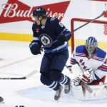 
              Winnipeg Jets' Saku Maenalanen (8) jumps out of the way as New York Rangers goaltender Jaroslav Halak (41) makes a save on a shot from the point during the second period of an NHL hockey game Friday, Oct. 14, 2022, in Winnipeg, Manitoba. (John Woods/The Canadian Press via AP)
            