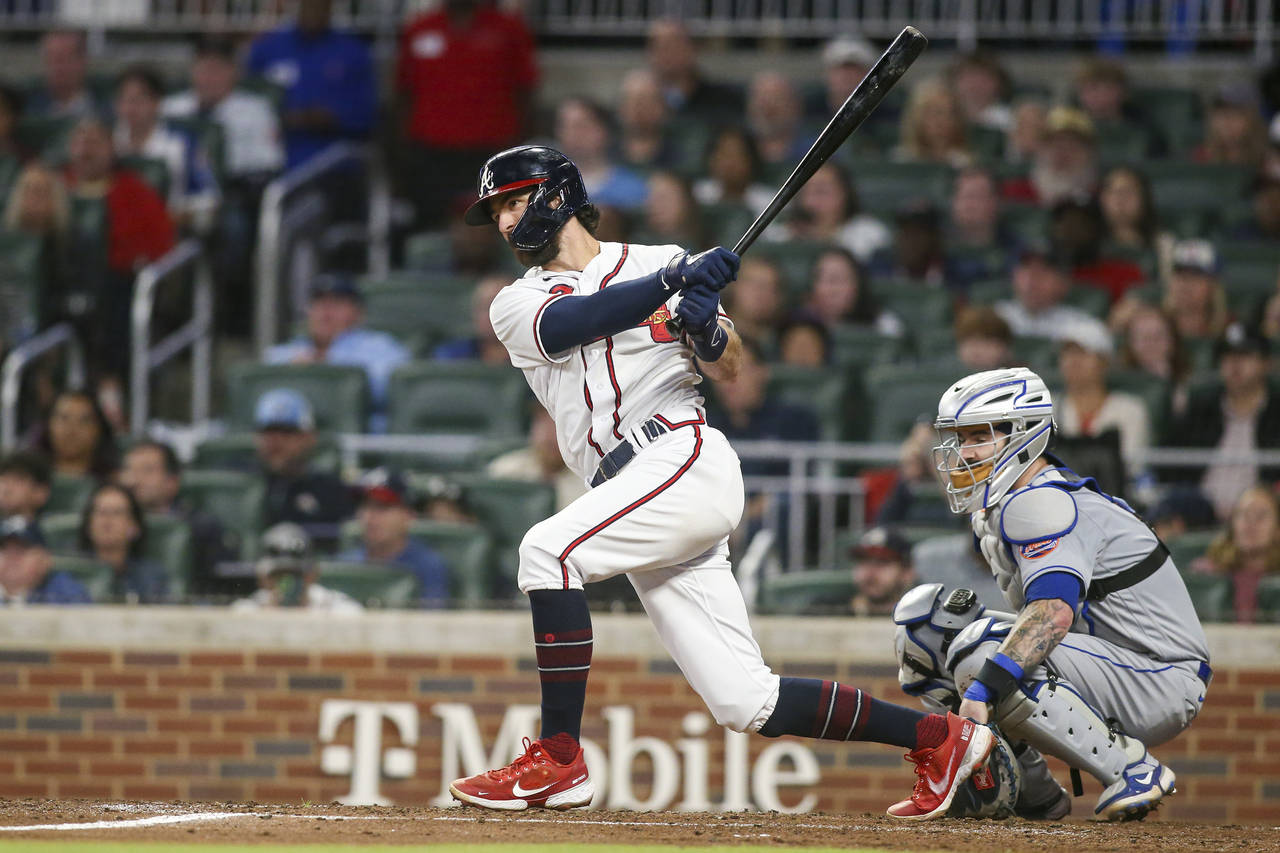 Atlanta Braves' Dansby Swanson follows through on a single during the third inning of the team's ba...