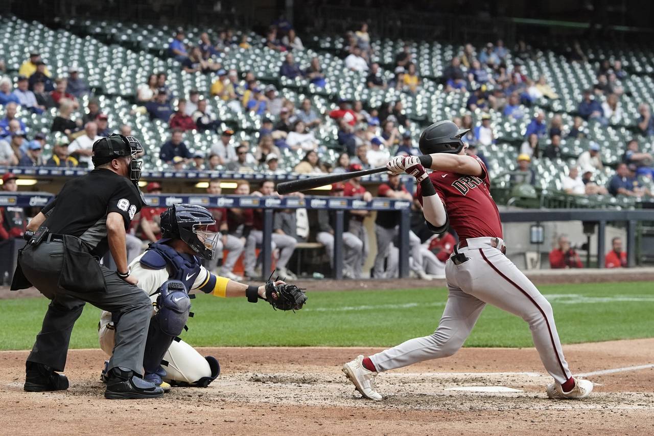 Arizona Diamondbacks' Josh Rojas hits a two-run home run during the ninth inning of a baseball game...