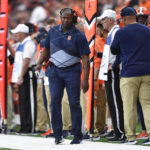 
              Syracuse head coach Dino Babers walks the sideline during the first half of an NCAA college football game against Notre Dame in Syracuse, N.Y., Saturday, Oct. 29, 2022. (AP Photo/Adrian Kraus)
            