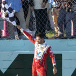 
              Kyle Larson waves the checkered flag after winning a NASCAR Cup Series auto race at Homestead-Miami Speedway, Sunday, Oct. 23, 2022, in Homestead, Fla. (AP Photo/Lynne Sladky)
            