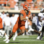 
              Oklahoma State quarterback Spencer Sanders (3) scrambles during the first half of an NCAA college football game against Texas, Saturday, Oct. 22, 2022, in Stillwater, Okla.(AP Photo/Brody Schmidt)
            