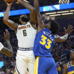 
              Denver Nuggets center DeAndre Jordan (6) is fouled while shooting against Golden State Warriors center James Wiseman (33) during the first half of an NBA basketball game in San Francisco, Friday, Oct. 21, 2022. (AP Photo/Jeff Chiu)
            