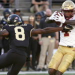 
              Boston College wide receiver Zay Flowers (4) avoids a tackle by Wake Forest defensive back Isaiah Wingfield (8) en route to a touchdown run after a catch during the first half of an NCAA college football game in Winston-Salem, N.C., Saturday, Oct. 22, 2022. (AP Photo/Chuck Burton)
            
