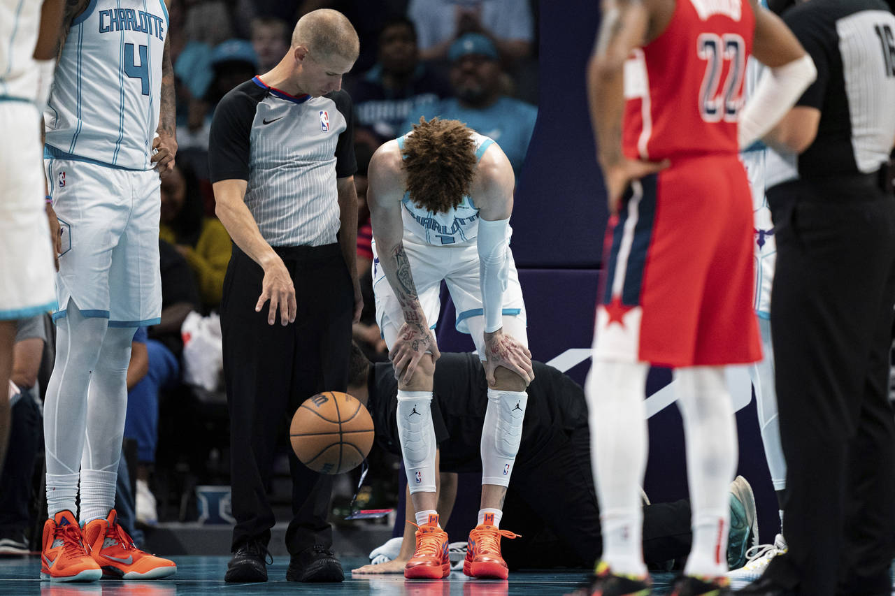 Charlotte Hornets guard LaMelo Ball is shaken up on a play in the second half of an NBA preseason b...