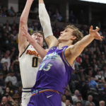 
              Denver Nuggets guard Christian Braun (0) goes up for a shot against Utah Jazz forward Lauri Markkanen (23) during the second quarter of an NBA basketball game Friday, Oct. 28, 2022, in Denver. (AP Photo/Jack Dempsey)
            
