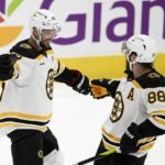 
              Boston Bruins center David Krejci (46) celebrates his goal with right wing David Pastrnak (88) during the third period of the team's NHL hockey game against the Washington Capitals, Wednesday, Oct. 12, 2022, in Washington. The Bruins won 5-2. (AP Photo/Nick Wass)
            